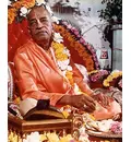 Srila Prabhupada at New Dwaraka, Holding Cookie on Vyasasana